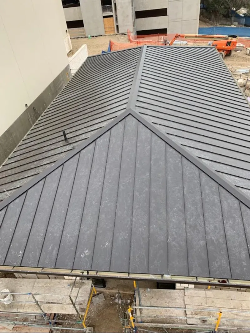 Commercial metal roof construction with crane equipment in Dardenne Prairie