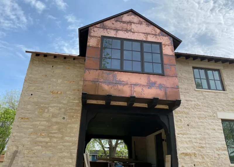 Copper metal panel facade on a stone building for Skylight Installation in Dardenne Prairie